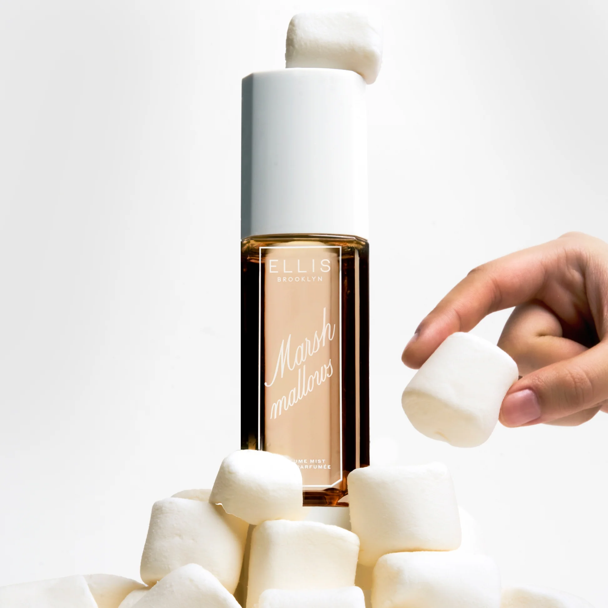 Bottle of Ellis Brooklyn Marshmallows perfume with marshmallows on a light background