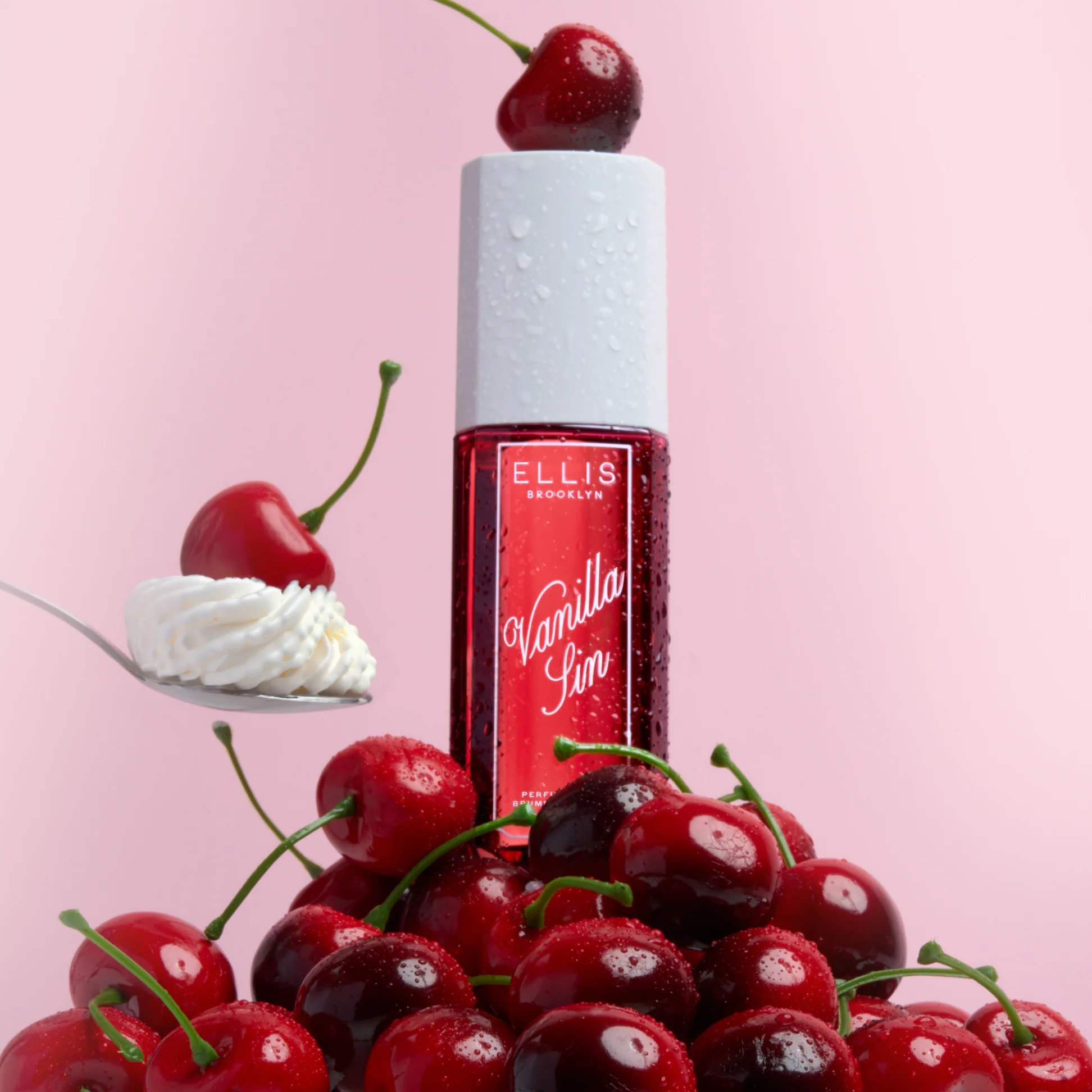 Red bottle of Ellis Brooklyn Vanilla SIN with cherries and whipped cream on a pink background