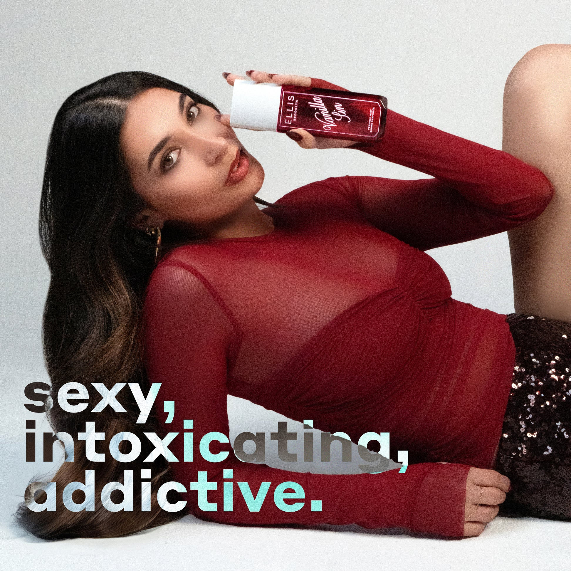 Woman in red dress holding a bottle with text 'sexy, intoxicating, addictive.'