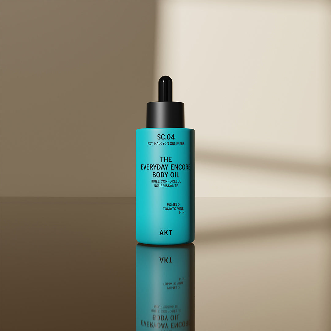 Bottle The Everyday Encore Body Oil Sc.04 by AKT on a beige background