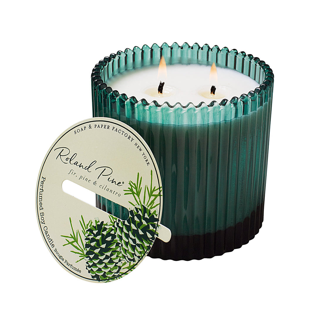 Roland Pine Green candle with a ribbed design and visible flames, featuring a label on a white background.