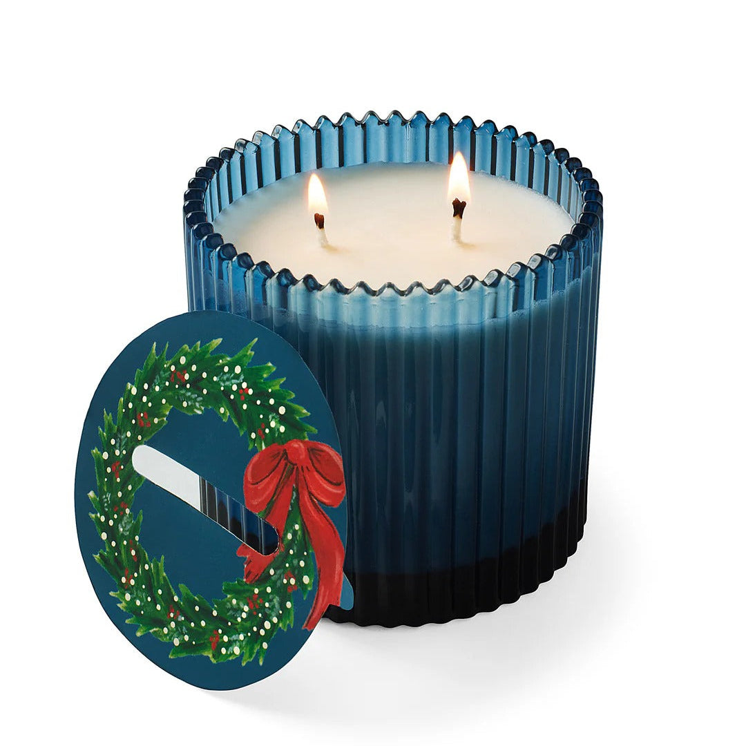 Roland Pine Blue candle with a festive design on a white background