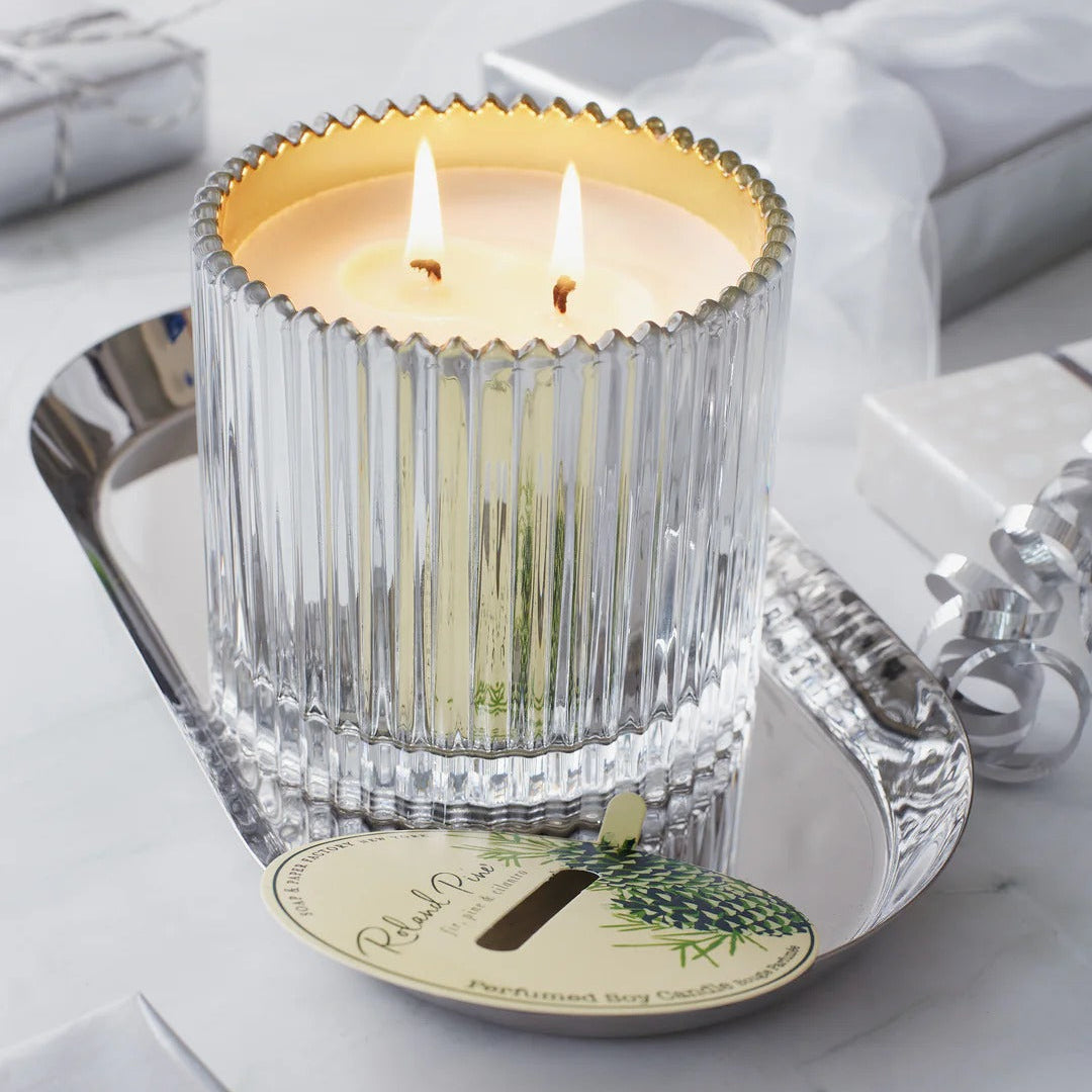 Roland Pine Candle in a decorative glass holder on a silver tray with a white background