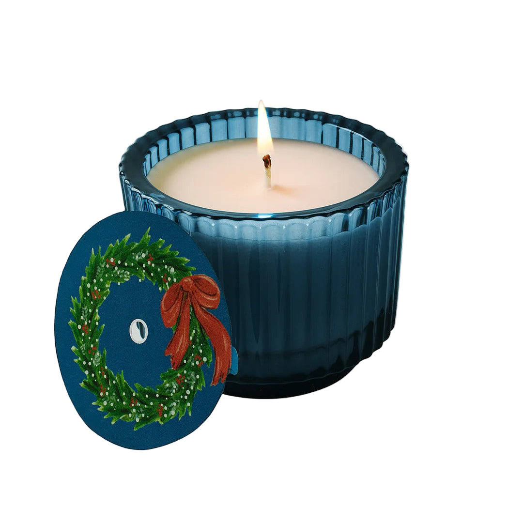 Roland Pine Blue candle with a festive design on a white background