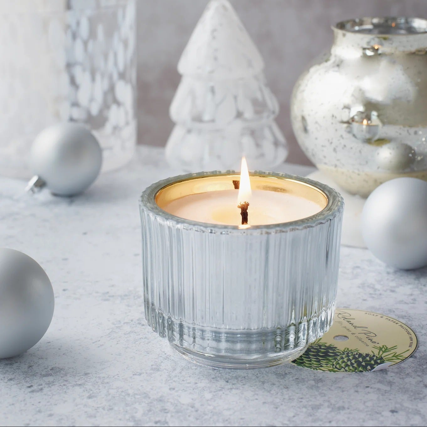 Soap & Paper Roland Pine candle decorative items on a light surface.