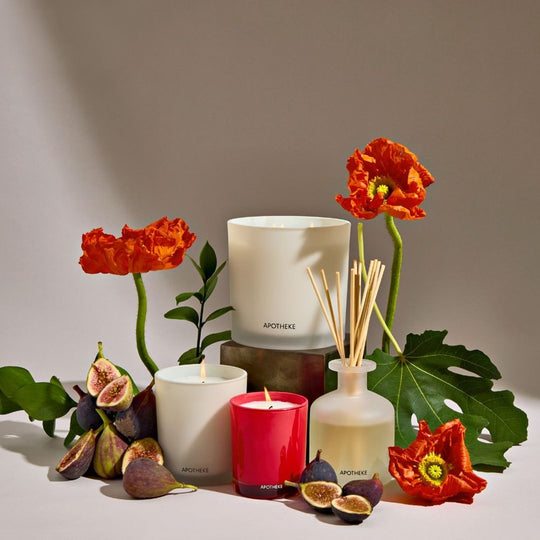 Fig And Olive Leaf Apotheke candles and diffusers with flowers and figs on a neutral background