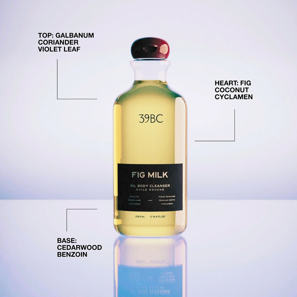 A clear bottle of 39BC Fig Milk Oil Body Cleanser with a black label and dark cap, centered on a light gradient background with text callouts describing the scent notes.