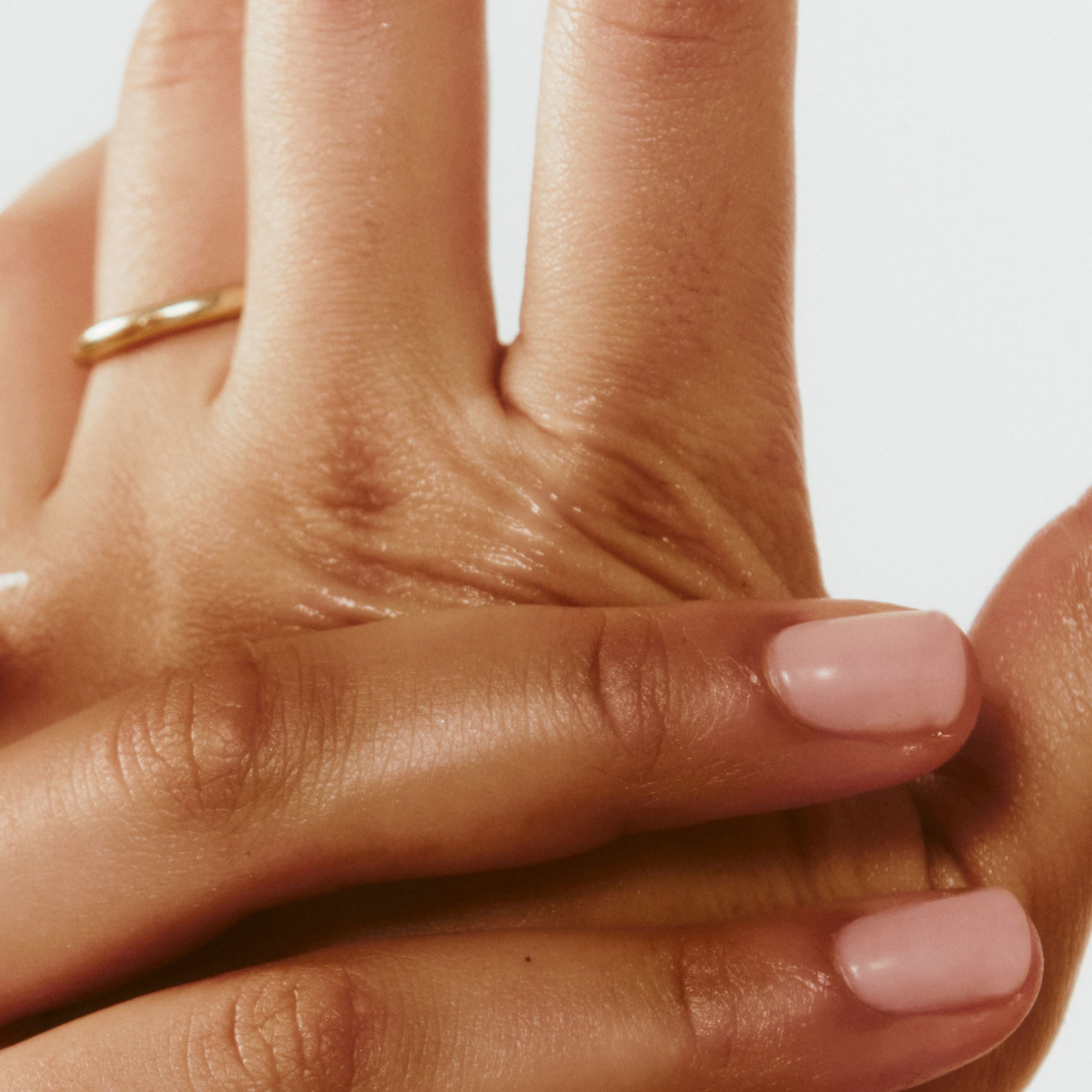 Closeup of hands rubbing in product