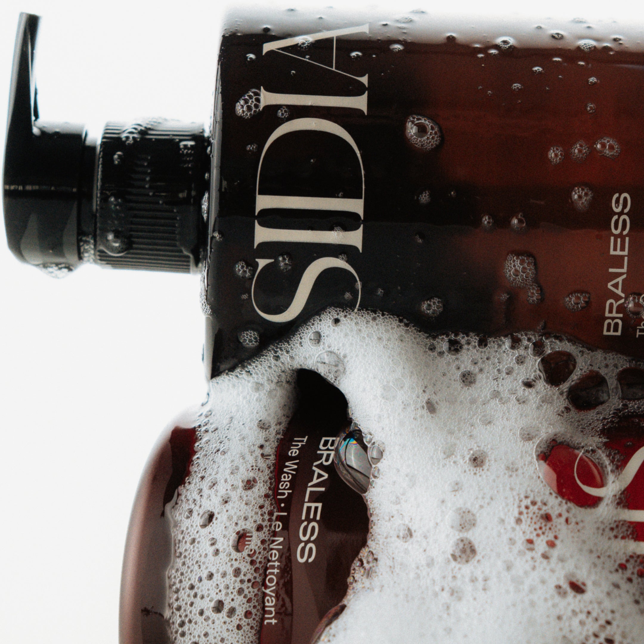 SIDIA "The Wash" bottles amid soap suds
