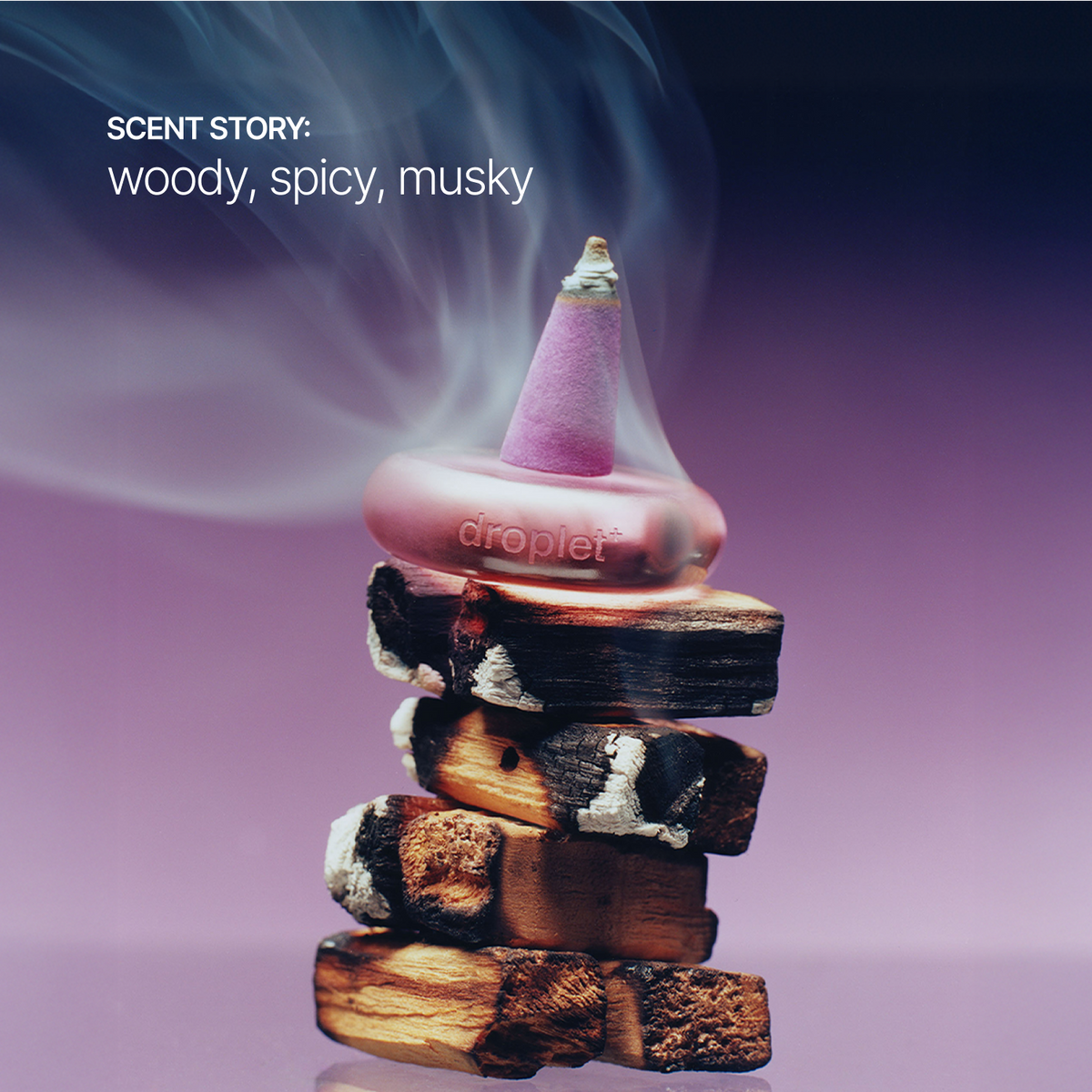 A droplet incense burner sits atop a stacked arrangement of burning wood logs, with smoke rising and the words 'SCENT STORY: woody, spicy, musky' on the left, against a purple gradient background.