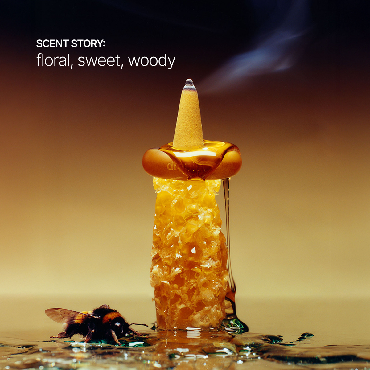 A styled product shot of a conical incense holder filled with honeycomb and amber resin, with a bumblebee at the base and a smoky vapor plume rising. White text in the upper left reads 'SCENT STORY: floral, sweet, woody'.