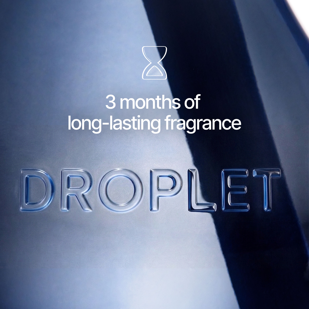 Close-up of a metallic droplet-shaped bottle with the word 'DROPLET' embossed on the front and white text reading '3 months of long-lasting fragrance' with an hourglass icon above it.