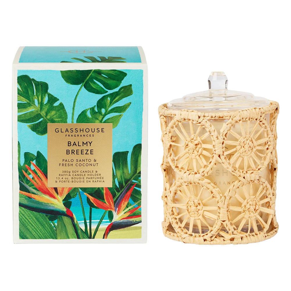 Balmy Breeze Candle and box with leaf pattern on a white background. 