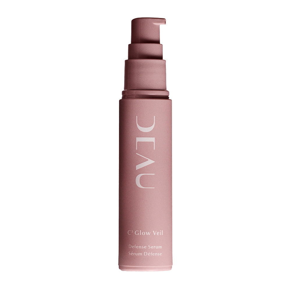 Pink skincare serum bottle with pump on a white background