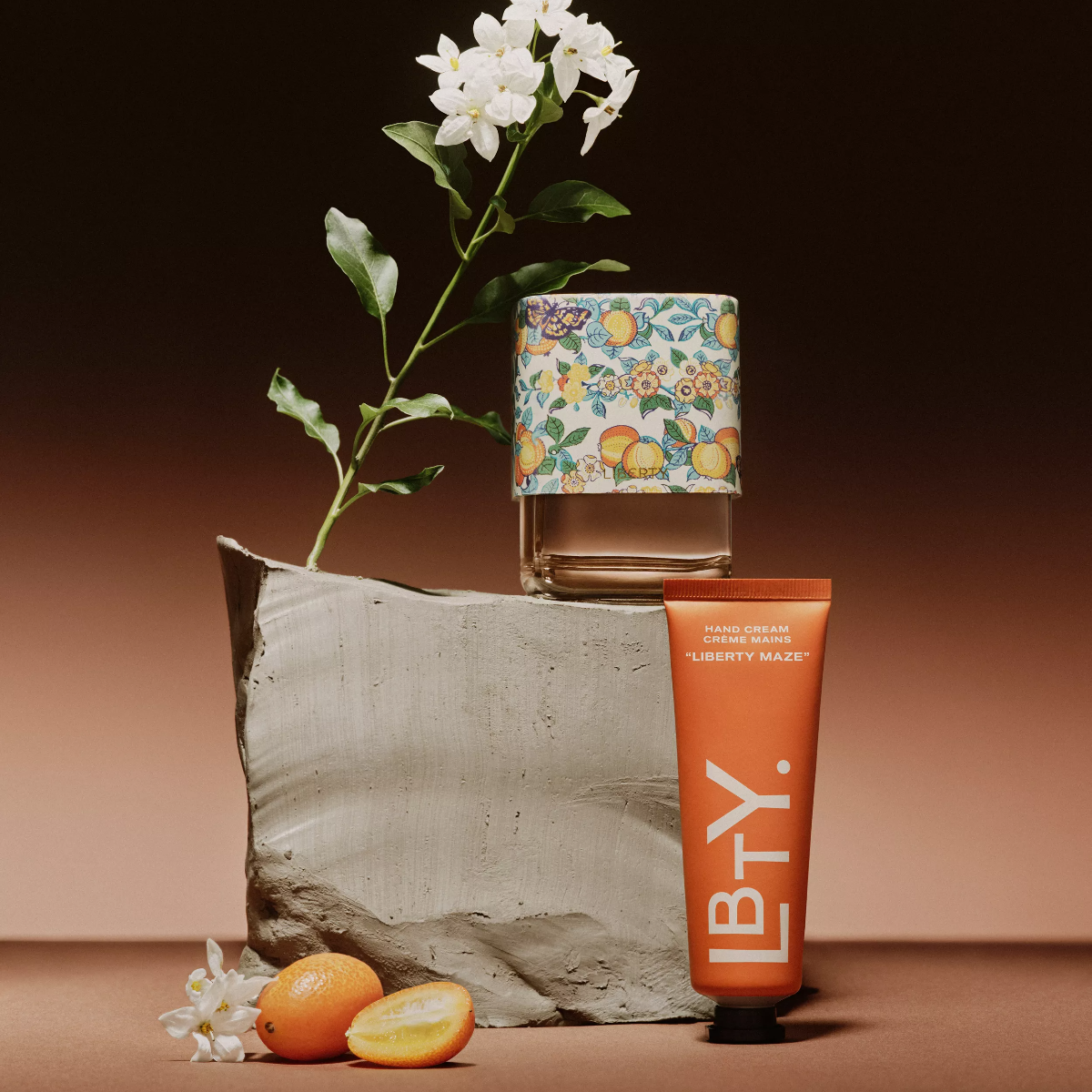 Product display with a tube of LBTY cream, a small box, and decorative elements on a brown background.