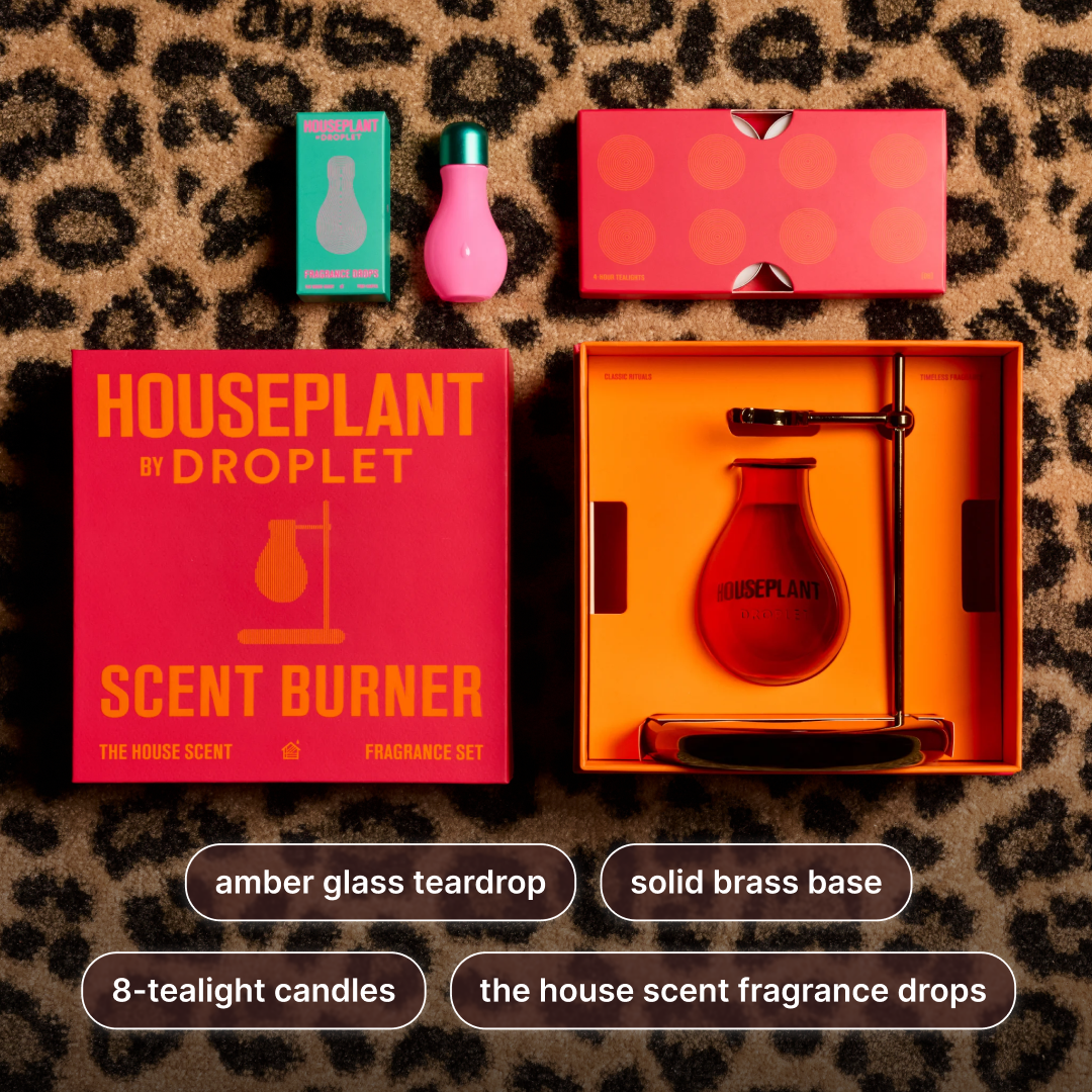 A fragrance set laid out on a leopard-print surface: a bright pink Houseplant by Droplet scent burner box, a pink perfume bottle with a green cap, a teal candle box, an orange tray holding an amber glass teardrop-shaped burner, and text labels below describing included items.