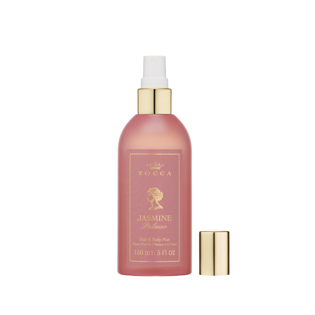 A bottle of TOCCA Jasmine Palazzo - Hair and Body Mist in a frosted pink spray bottle with gold detailing, shown with its gold cap off next to it on a white background.