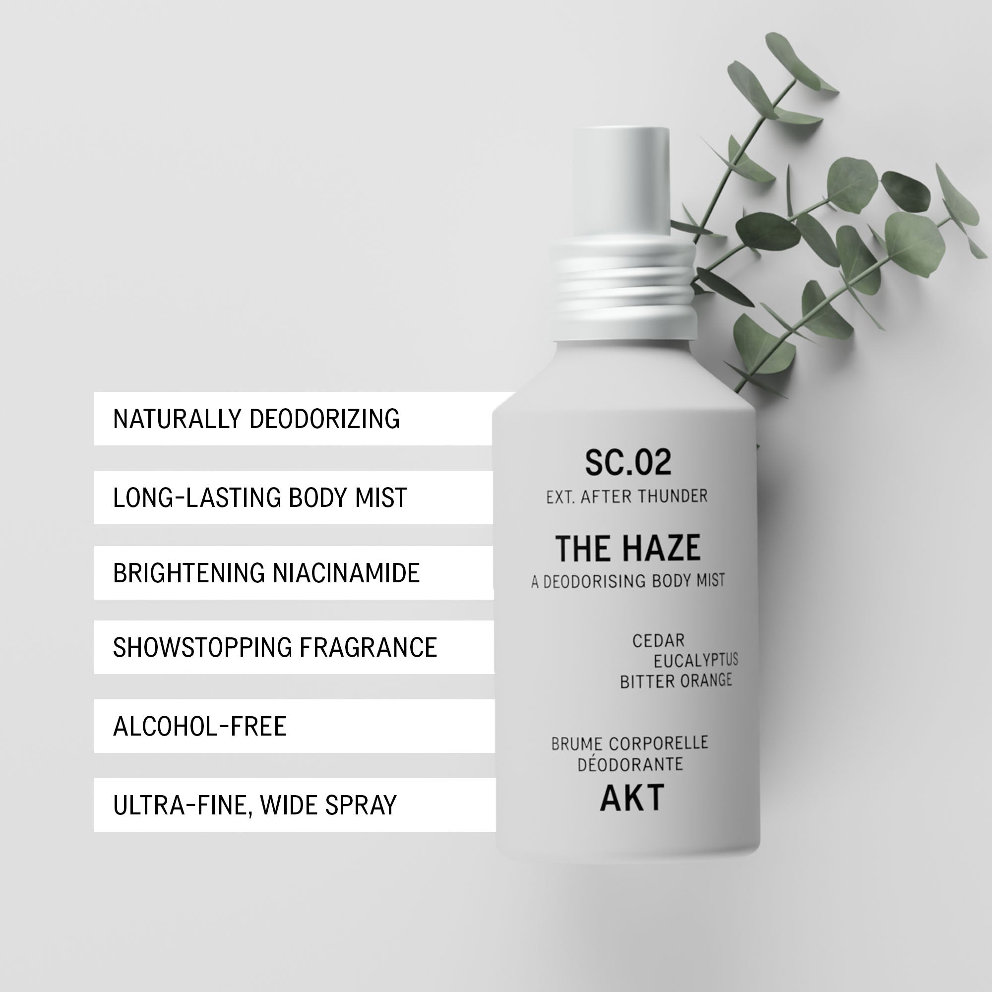Bottle of AKT The Haze SC. 02 After Thunder on a light gray background with a sprig of green eucalyptus leaves. To the left, a vertical list of text highlights product features such as naturally deodorizing and long-lasting body mist.