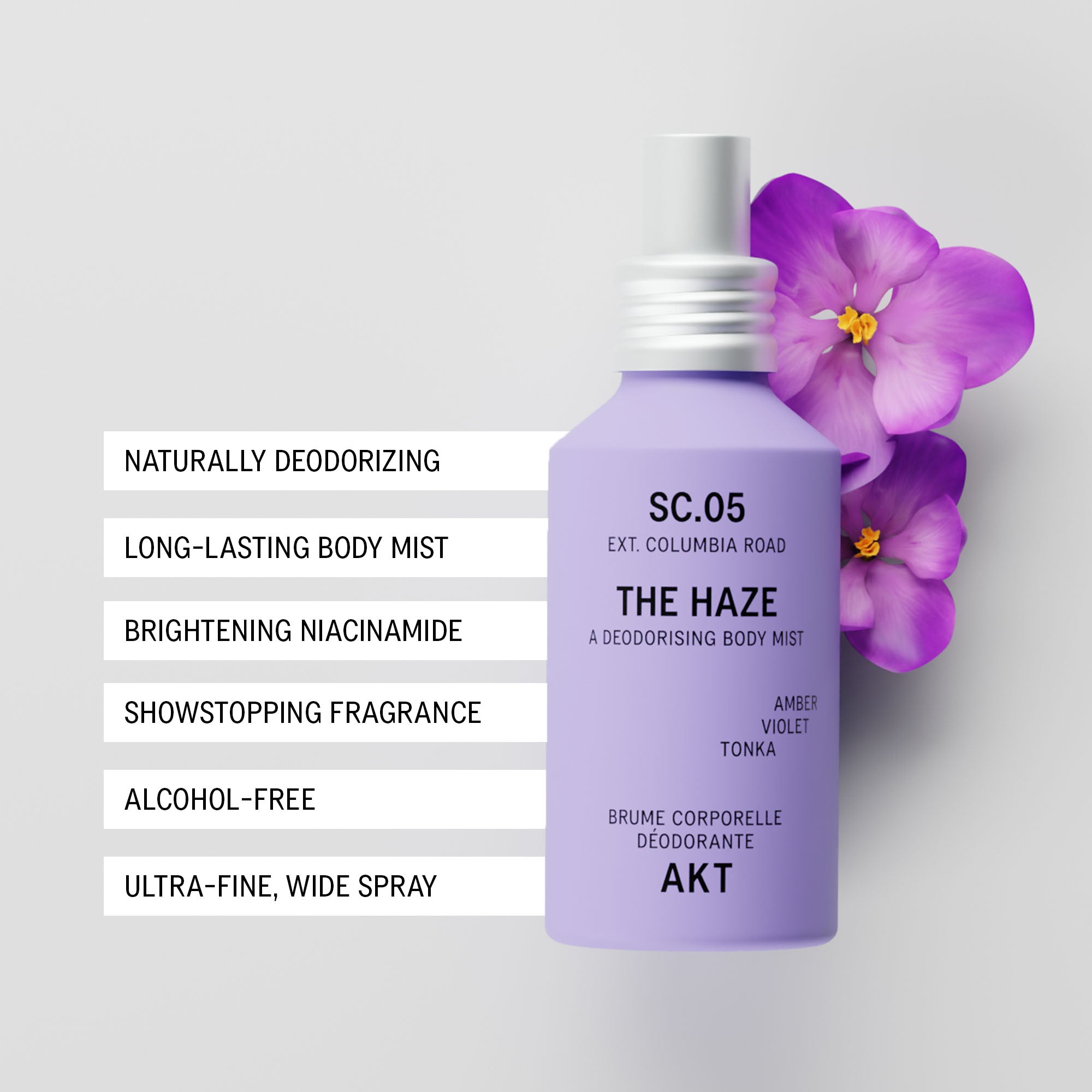 Bottle of AKT The Haze SC. 05 Columbia Road with a white spray nozzle, shown next to purple orchid flowers on a light gray background. To the left of the bottle is a white text strip listing product benefits in English.