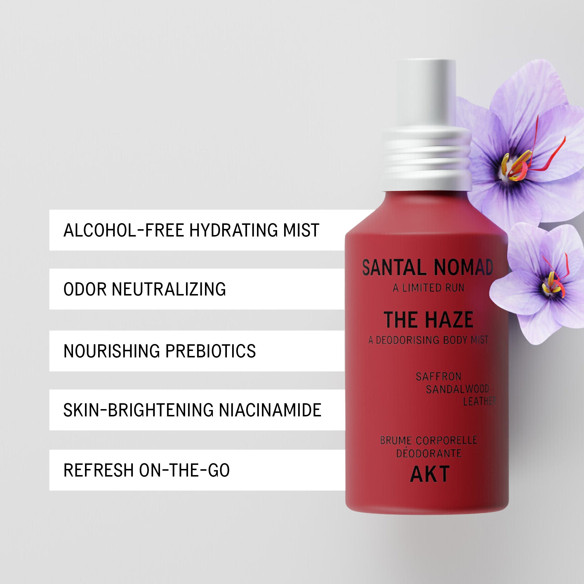 A red bottle of The Haze - Santal Nomad - Limited Edition deodorizing body mist with a white spray top, shown on a light gray background with purple flowers and a list of product benefits on the left.
