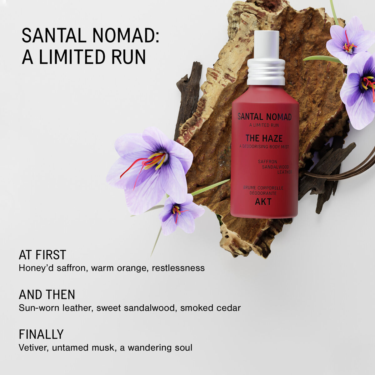 A bottle of The Haze - Santal Nomad - Limited Edition body styled on a light gray background with a piece of wood, dried leaves, and purple flowers. The left side features text detailing the scent notes and marketing copy for a limited run.