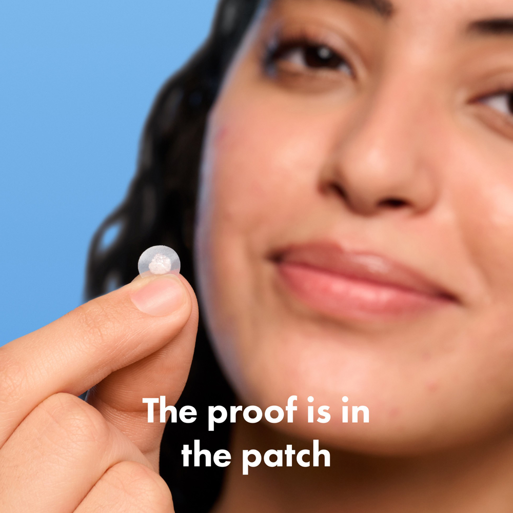 Person holding patch with text 'The proof is in the patch' on a blue background
