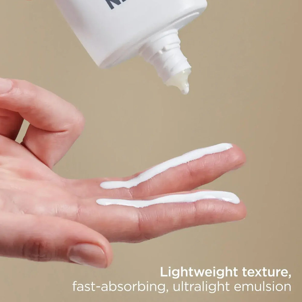 A hand applying ISDIN Eryfotona Actinica SPF 50+ to fingers on a solid beige background, with text at the bottom reading 'Lightweight texture, fast-absorbing, ultralight emulsion'.