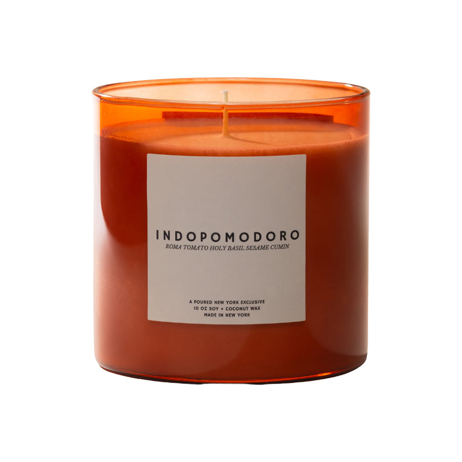 Candle with an orange transparent container and a label on a white background