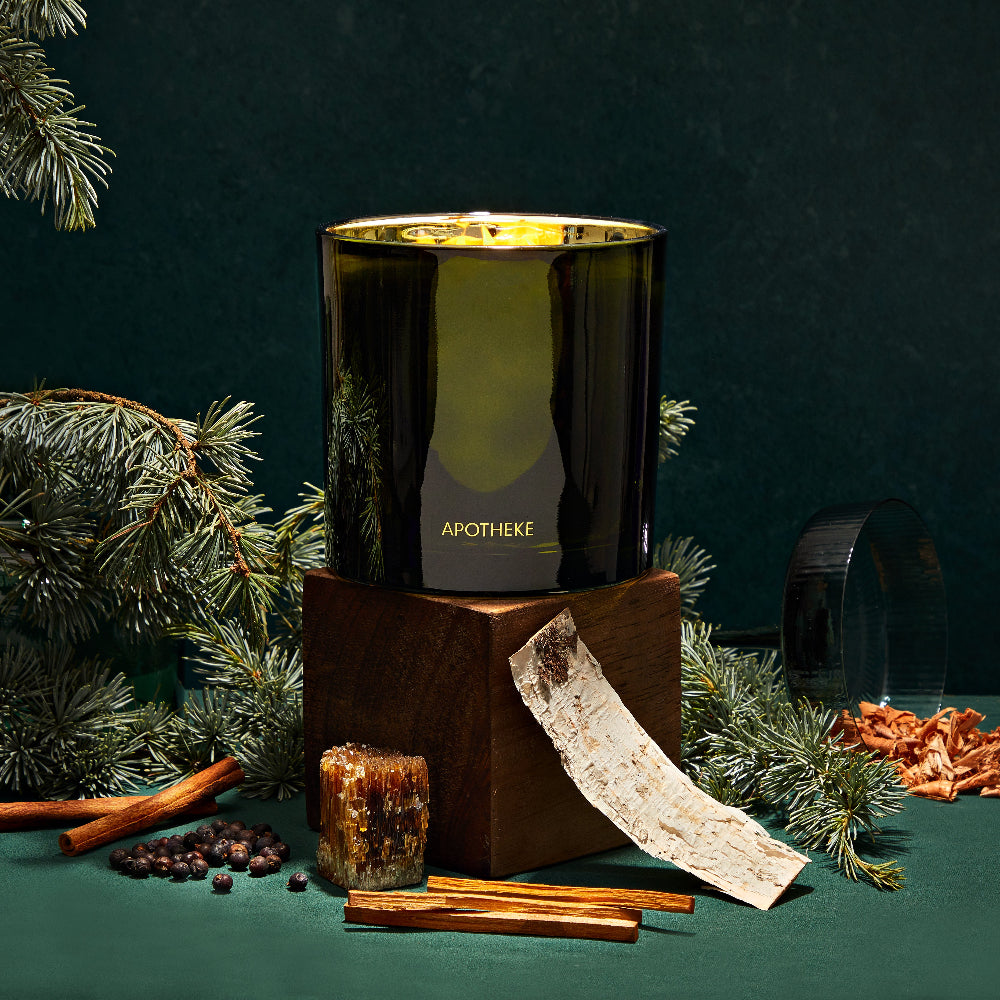 Apotheke candle with decorative elements on a dark green background