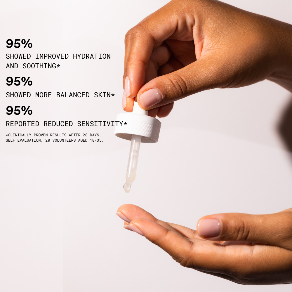 Hand holding a dropper with skincare product and text on improved hydration, balanced skin, and reduced sensitivity.