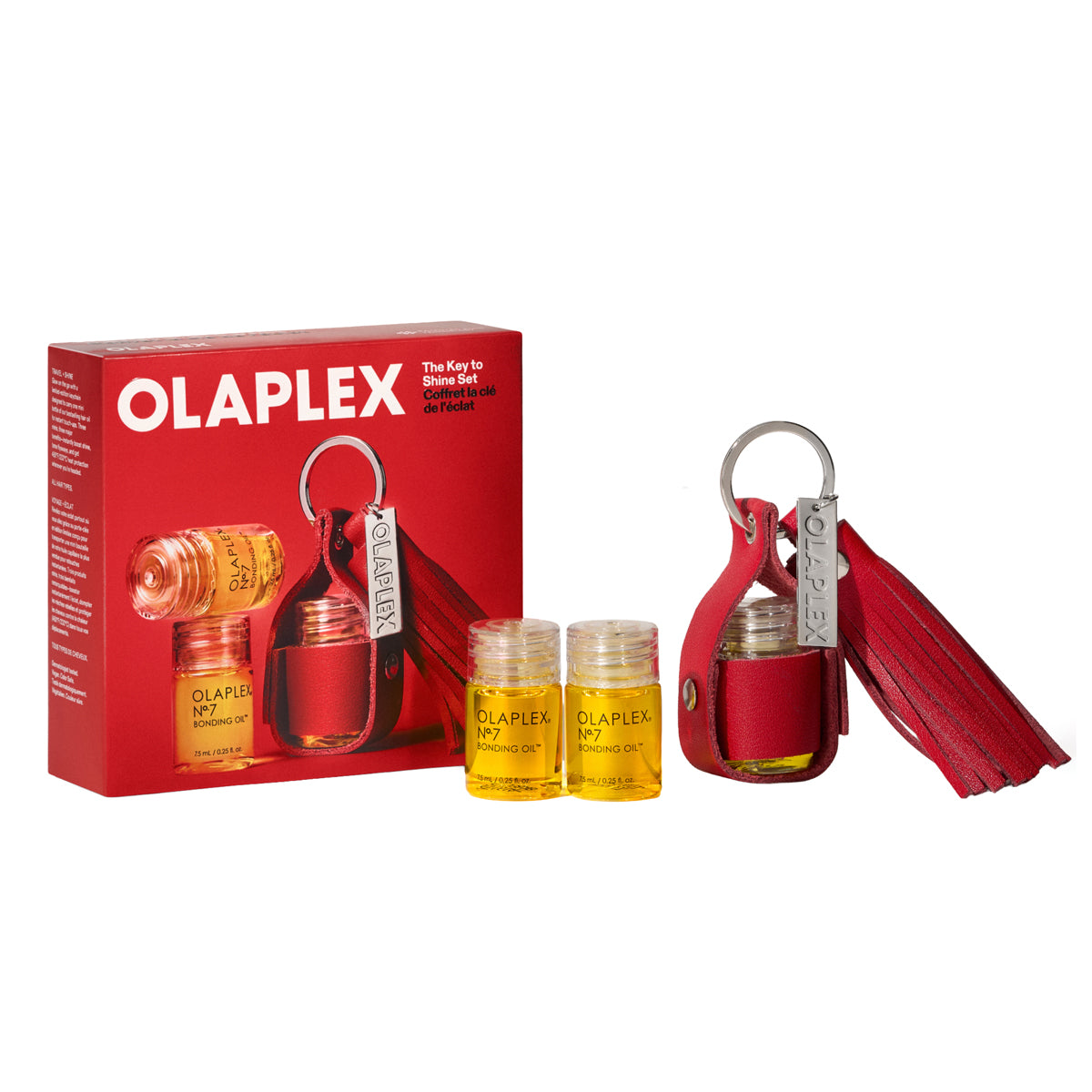 Olaplex Key to Shine gift set featuring a red leather tassel keychain, two small amber glass bottles with yellow liquid, and the red retail box on a white background.