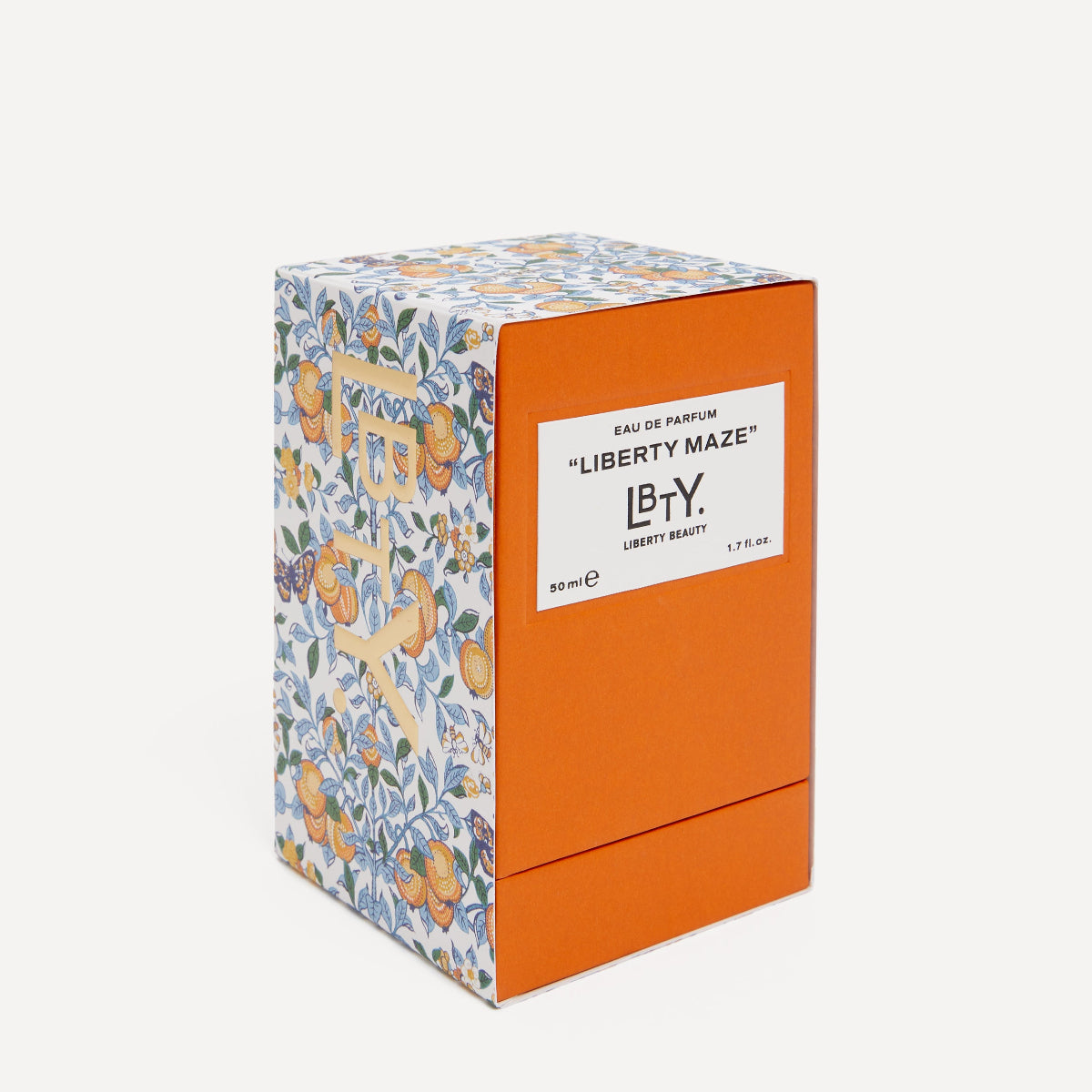 Perfume box with floral design and orange accents on a white background