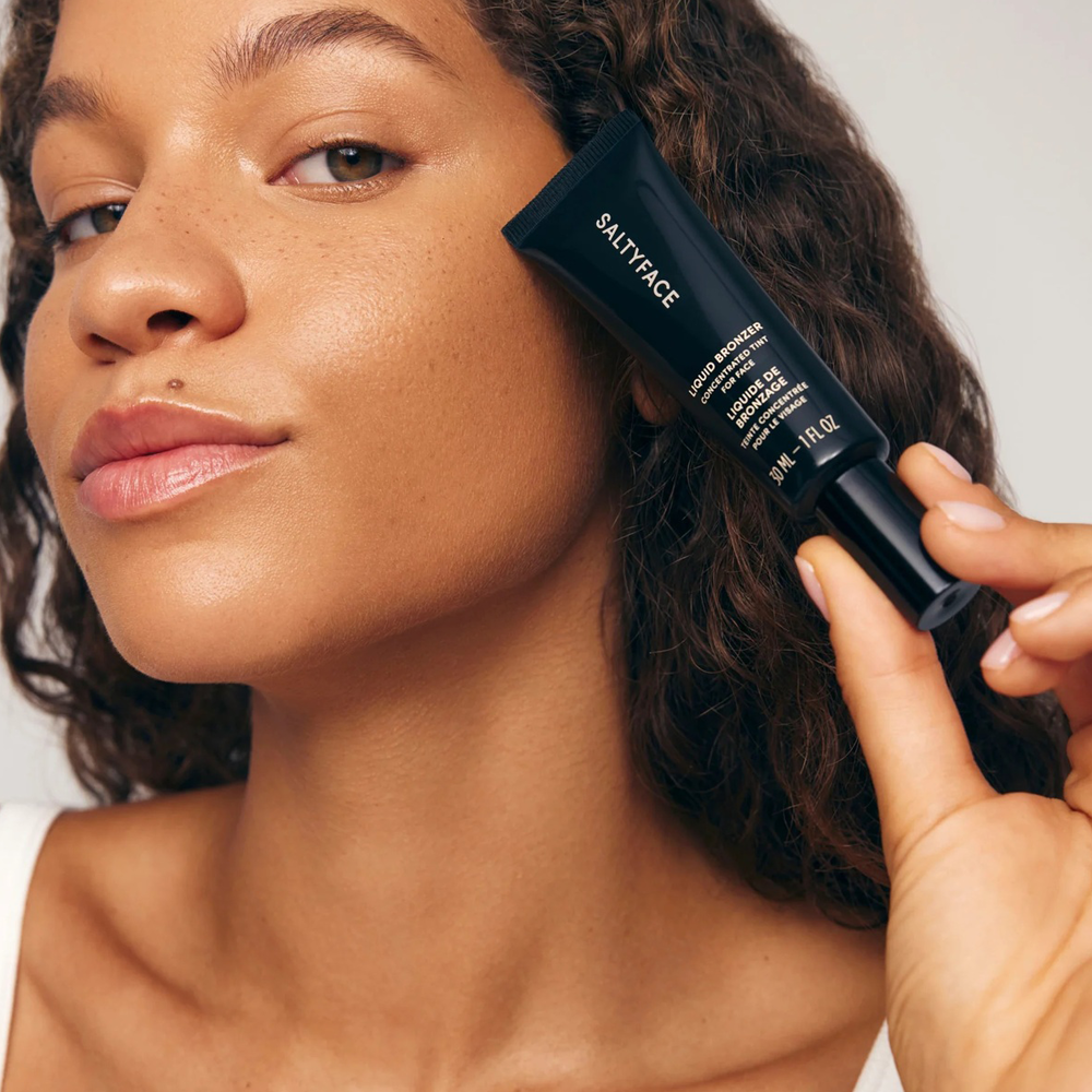 Woman holding a Salty Face product close to her face
