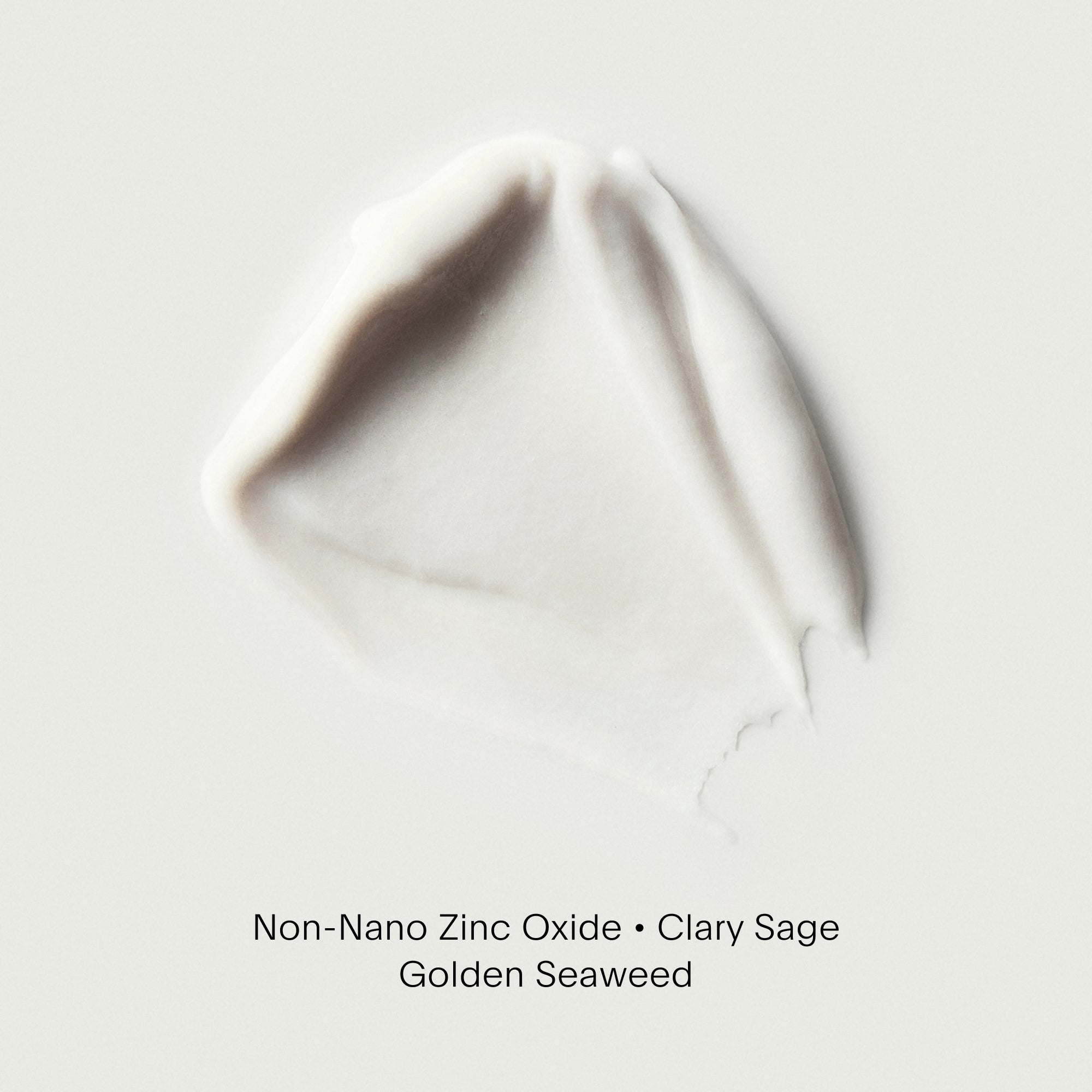 Clay-colored cosmetic product on a light gray background with text indicating 'Non-Nano Zinc Oxide • Clary Sage • Golden Seaweed'.