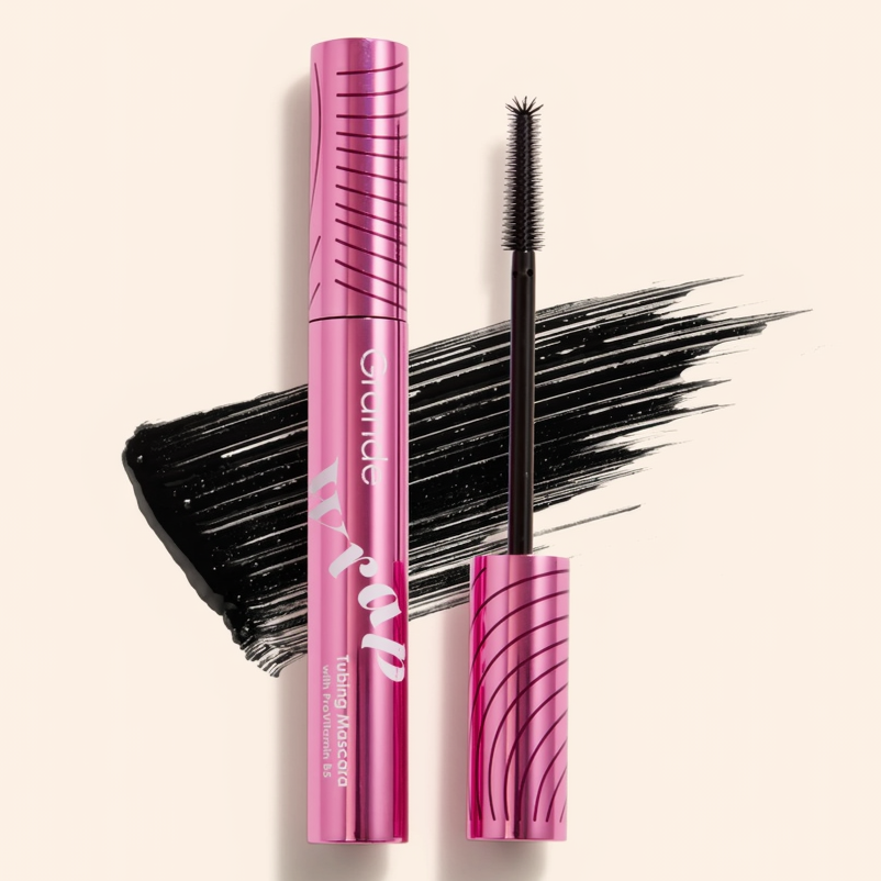 Pink mascara with black wand on a light pink background