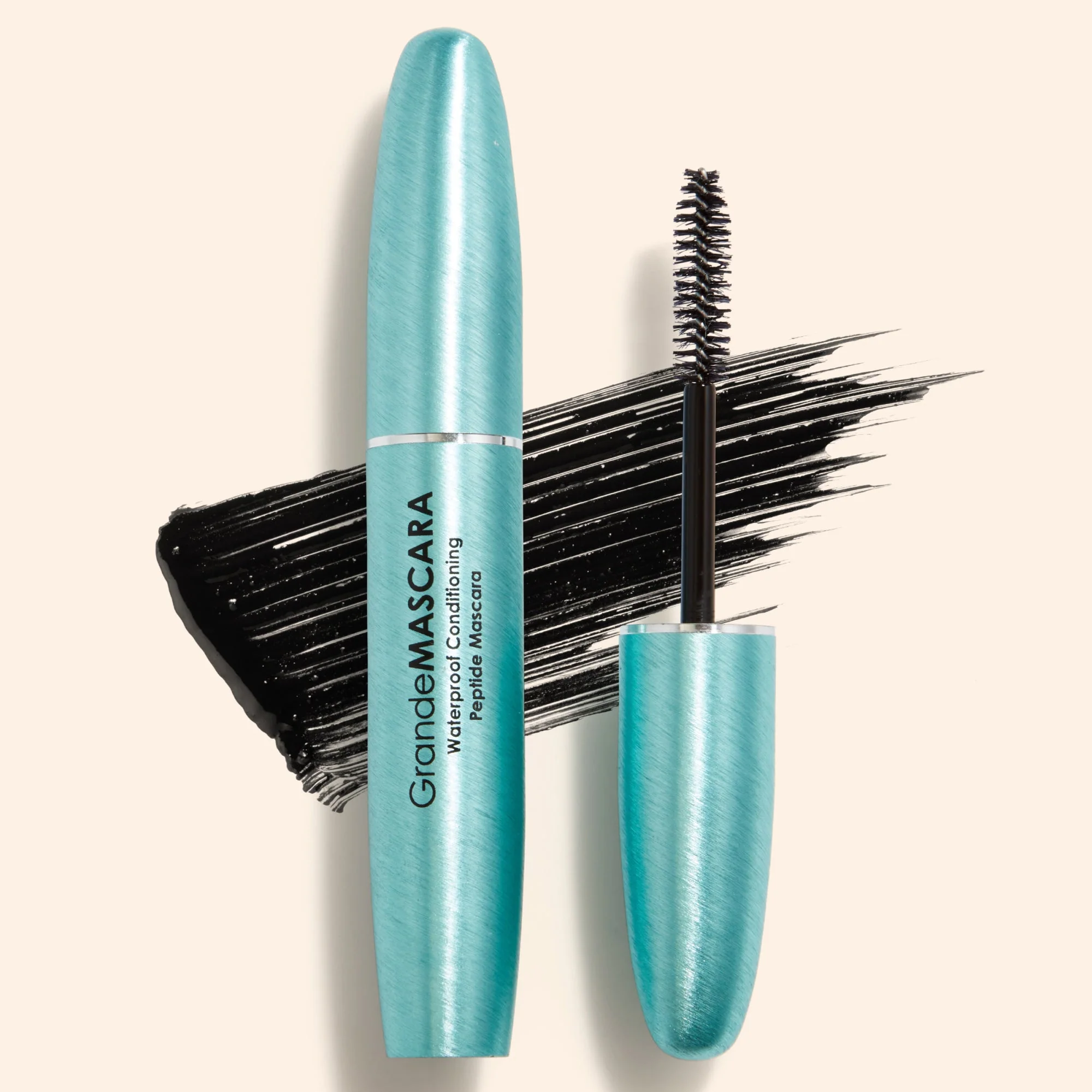Blue mascara with brush on a beige background