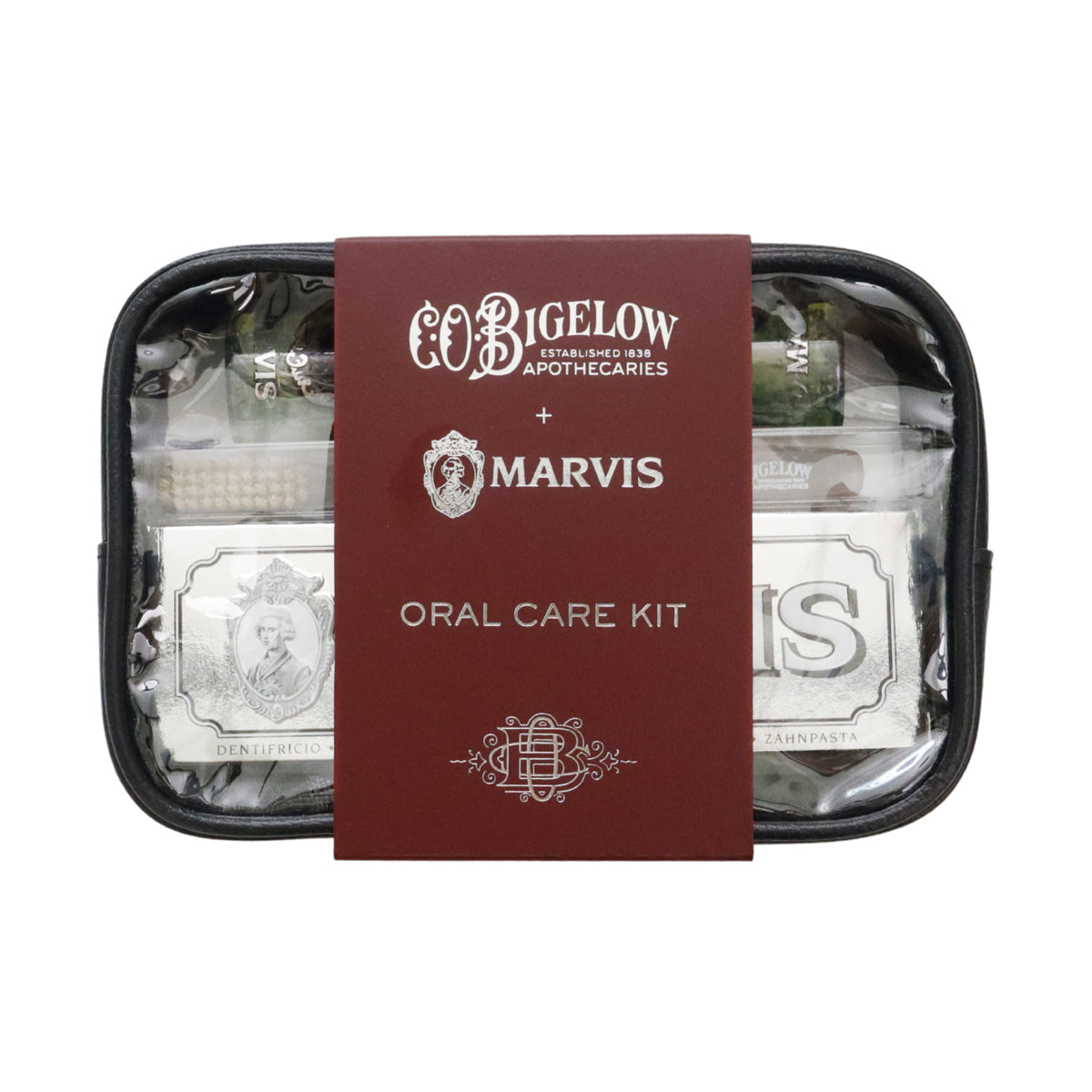 Co Bigelow Apothecaries and Marvis Oral Care Kit in a black zippered case with a burgundy paper sleeve in the center, photographed on a white background.