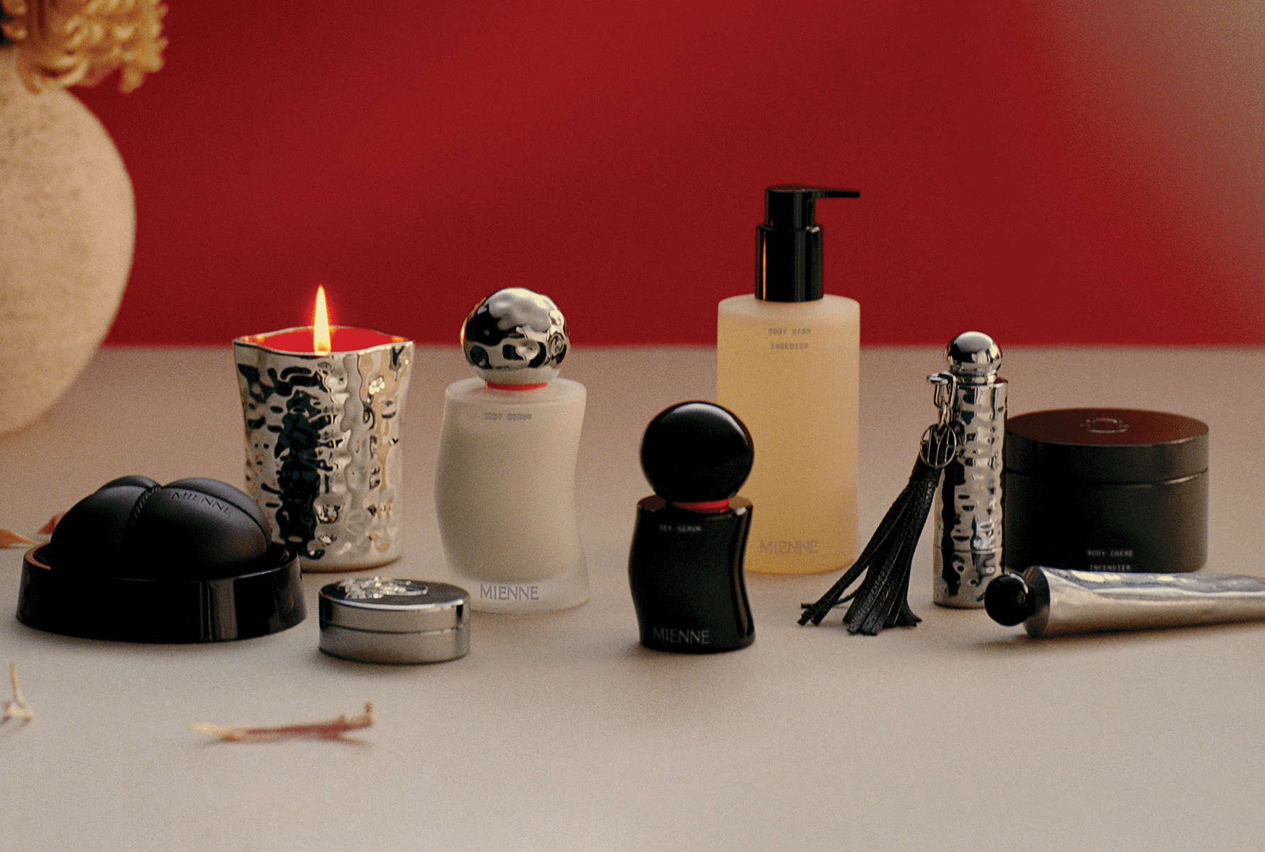 Mienne Product range on a tan surface in front of a red background.