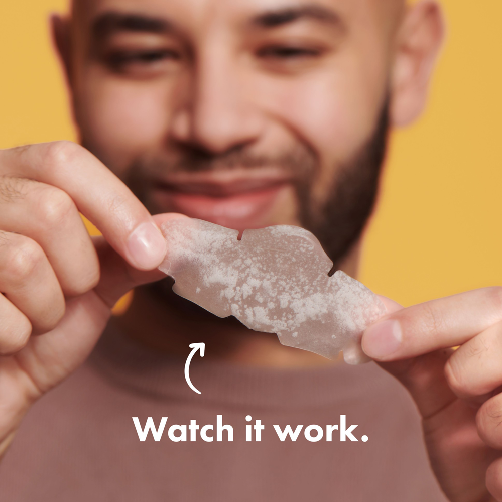 Man holding a small object with text 'Watch it work' on a yellow background