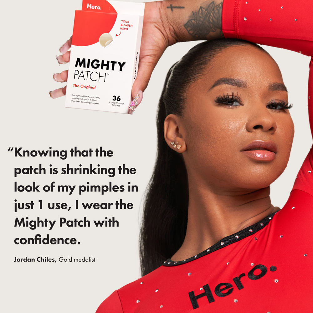 Woman wearing a red 'Hero' shirt with a Mighty Patch box and quote on a white background