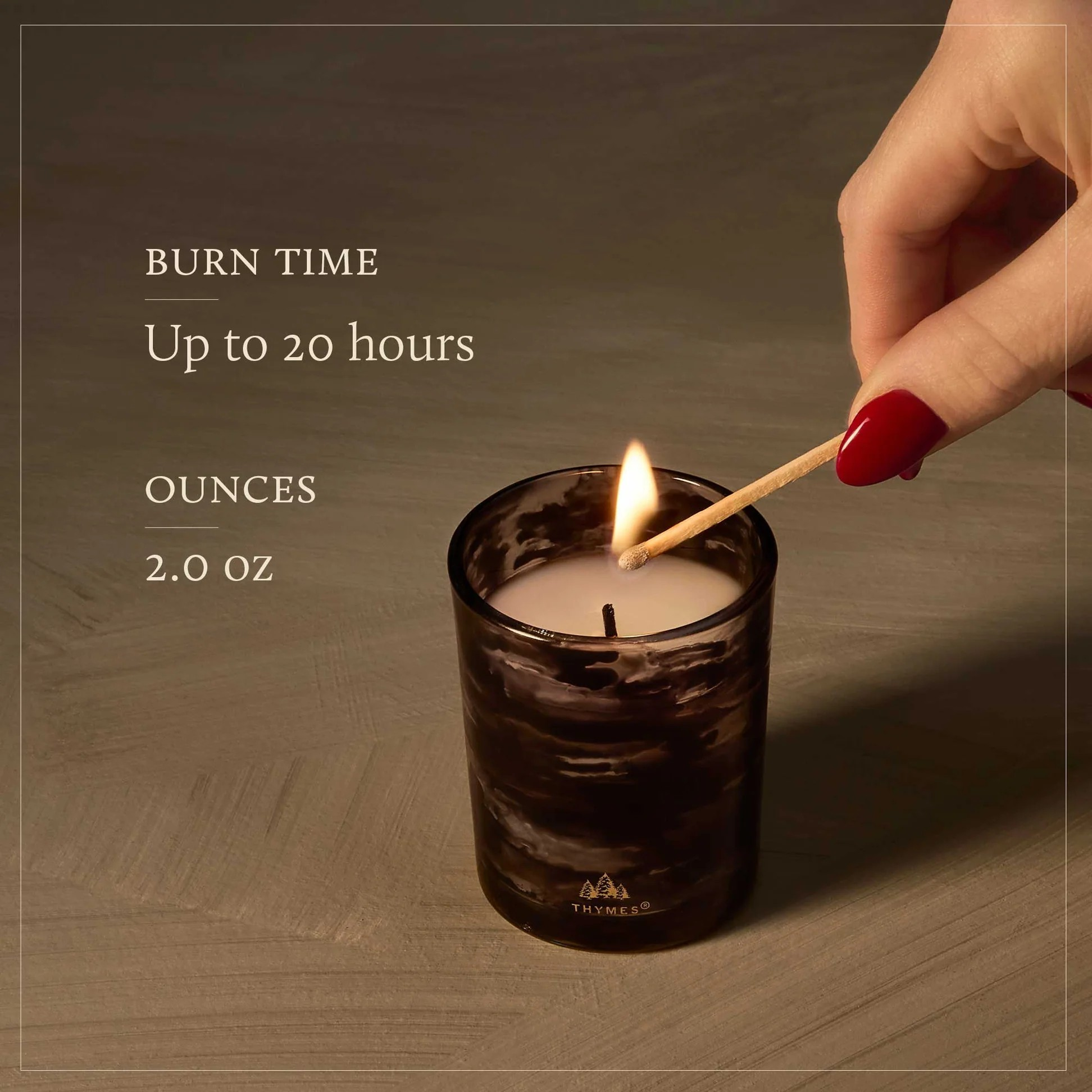 Candle being lit with text about burn time and ounces on a dark background