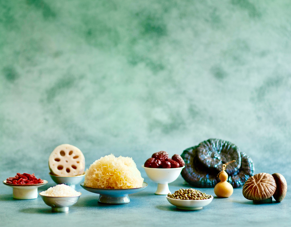 assorted mushrooms and natural ingredients on a green background