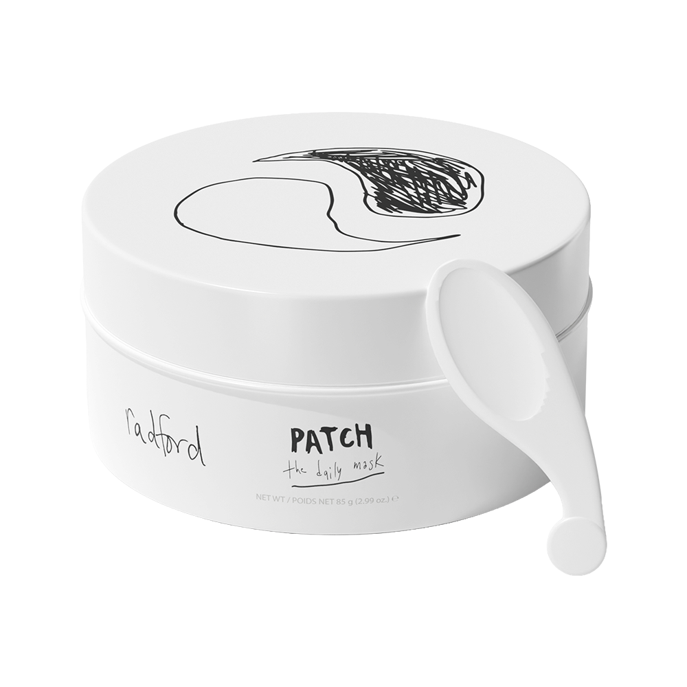 A white round jar of Radford Patch - the daily mask with a white plastic spatula resting on the side, shown against a solid white background.