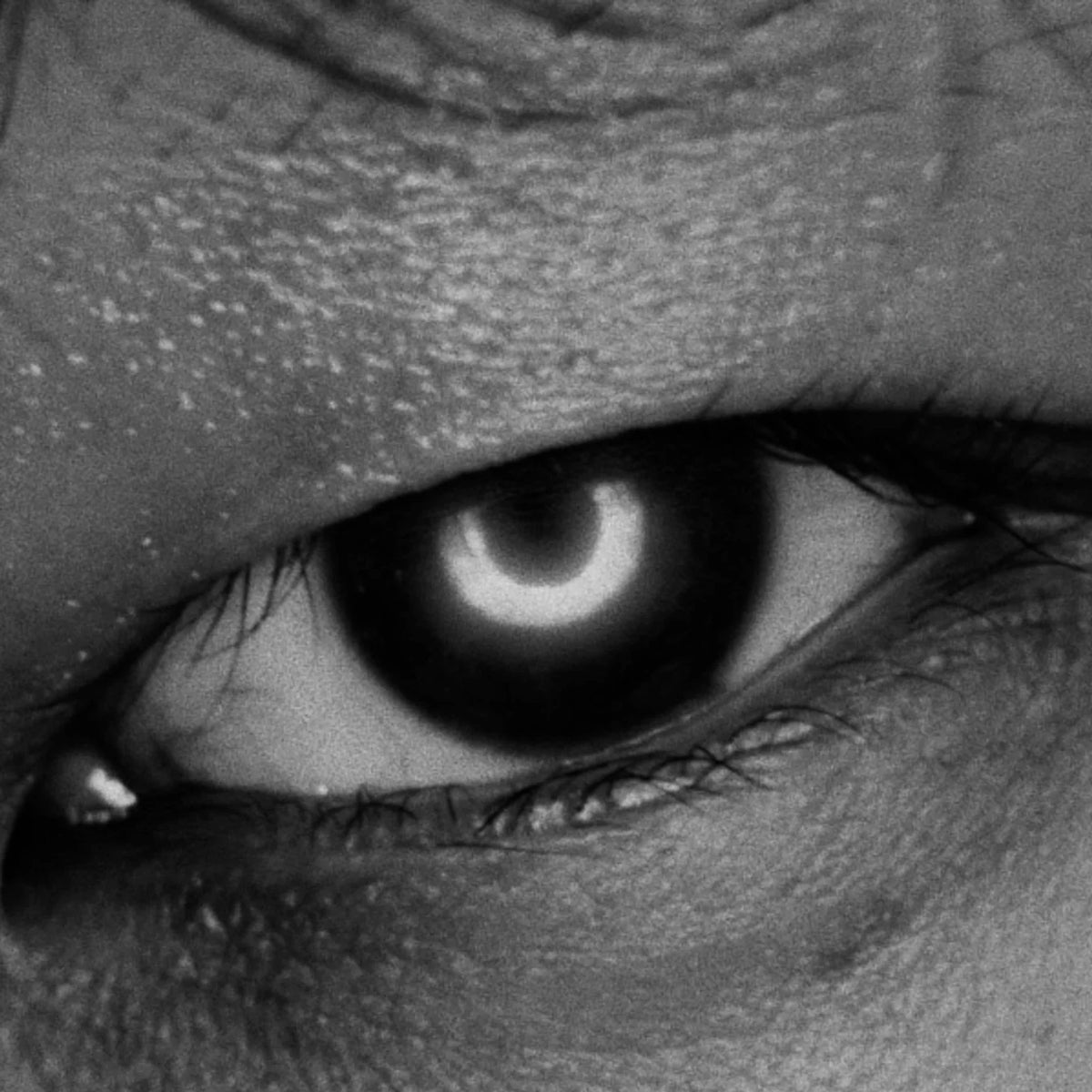 Close-up of a person's eye with a dark pupil.