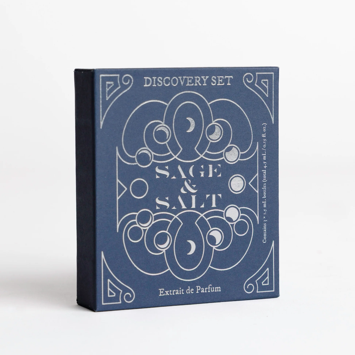 A square product box for a fragrance discovery set titled 'Sage & Salt' with 'Extrait de Parfum' printed on the front. The box is dark blue with white decorative line art and text, photographed on a clean white background.