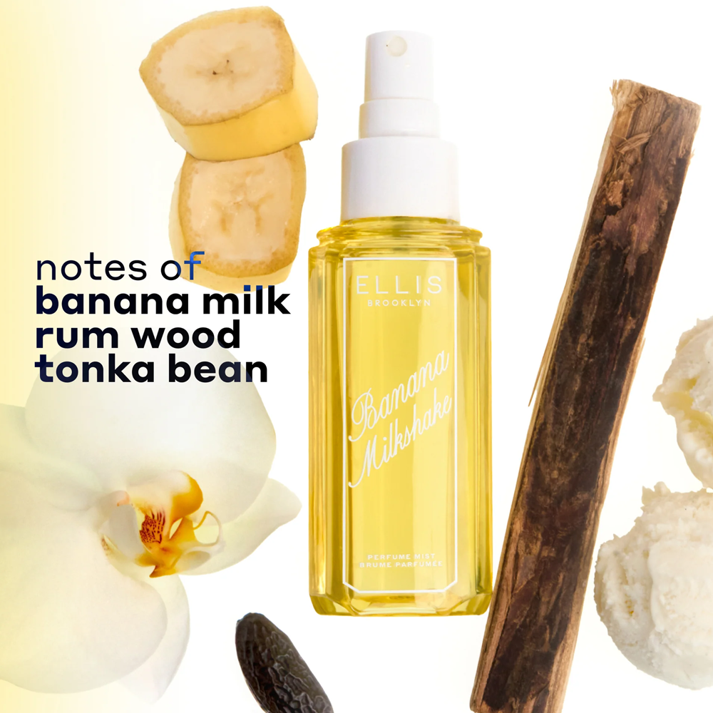 Yellow bottle of Ellis Brooklyn Banana Milkshake perfume with banana slices, wood, and orchid on a white background