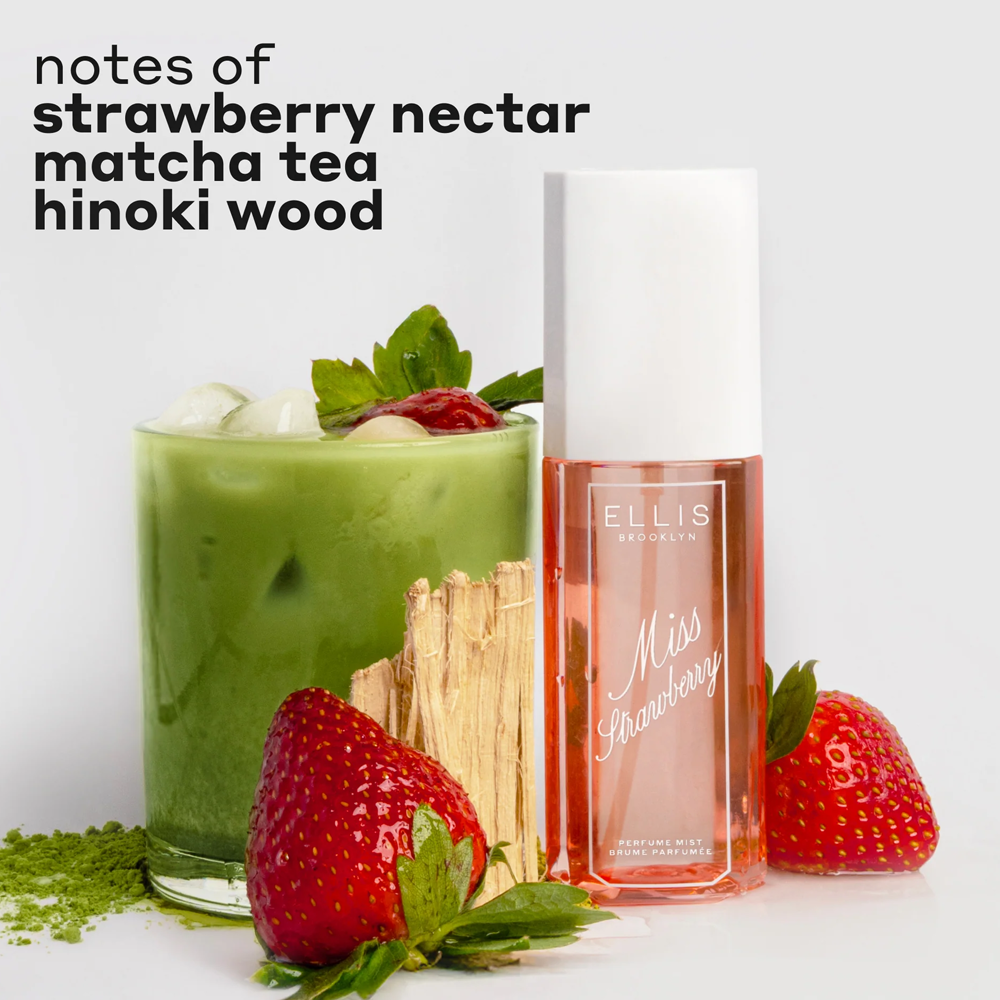 Perfume bottle labeled 'Miss Strawberry' next to a glass of strawberry matcha tea with strawberries and matcha leaves.