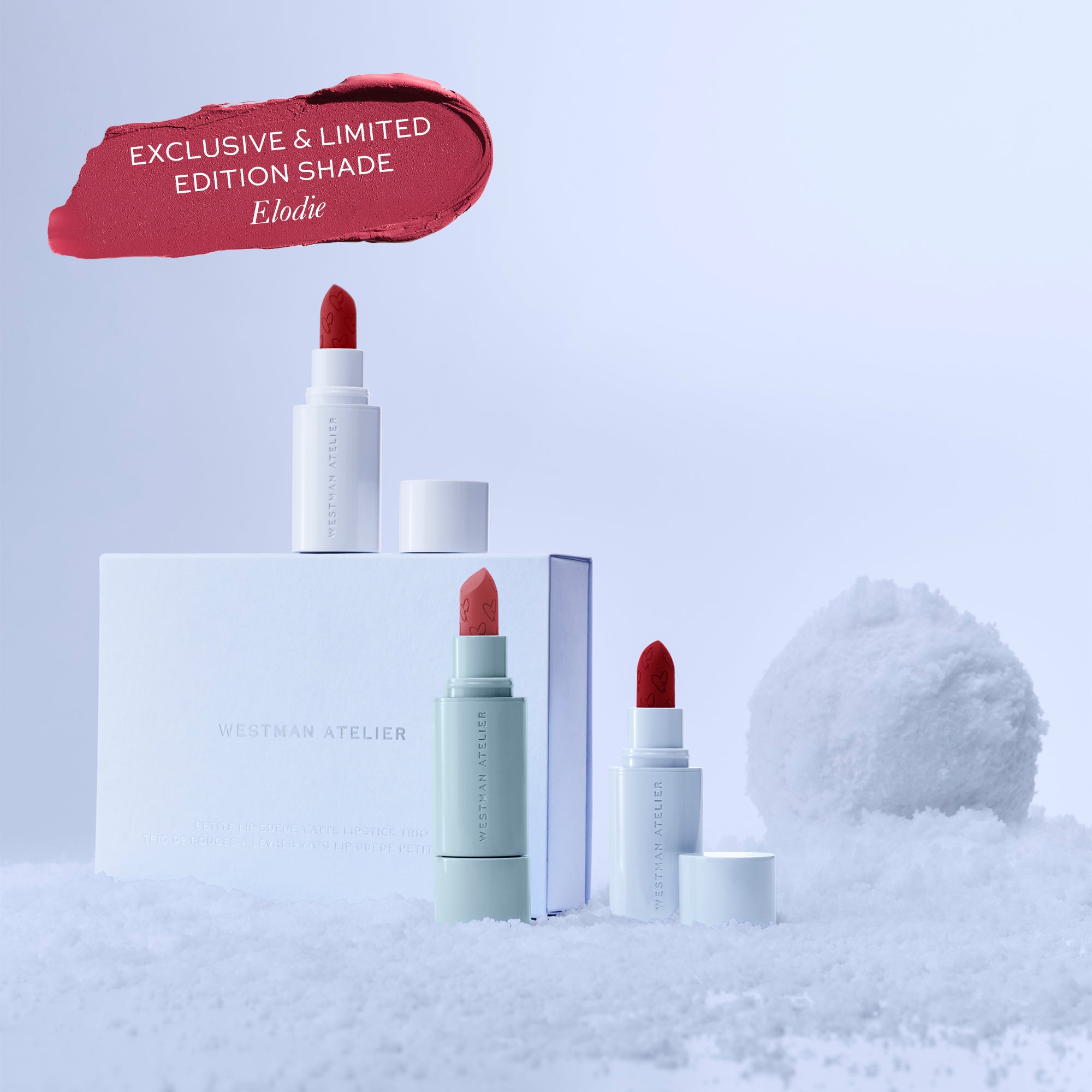 Red lipstick with packaging on a snowy background, featuring 'Exclusive & Limited Edition Shade Elodie' text.