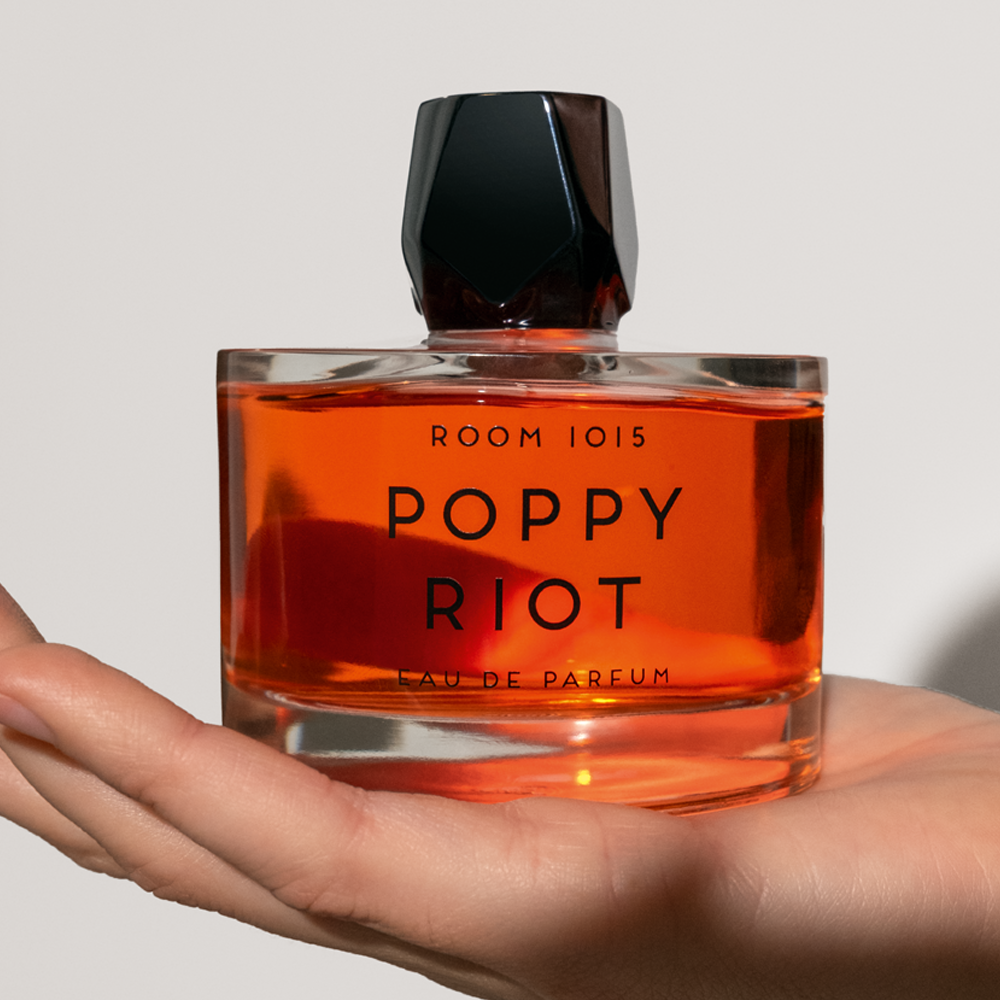 Hand holding Room 1015 Poppy Riot Eau De Parfum product