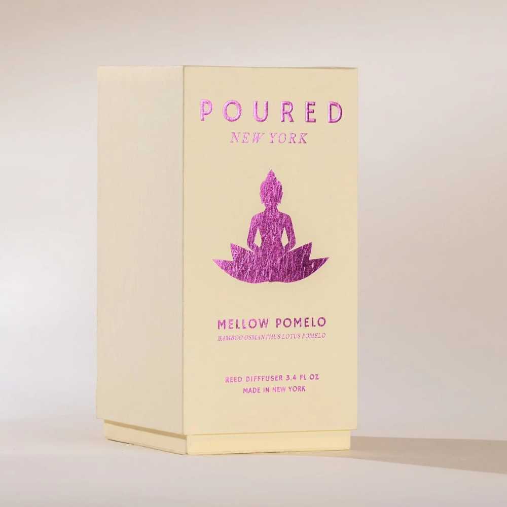 Product packaging with 'POURED NEW YORK' branding and a Buddha illustration on a light background